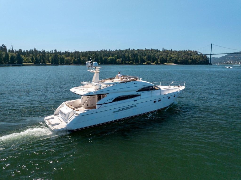 white yacht for sale cruising on the sea
