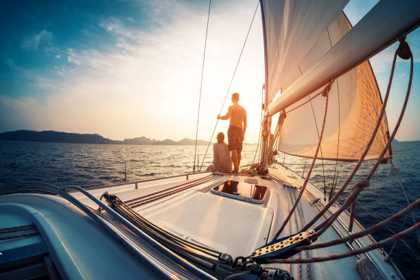 Couple enjoying sunset from the deck of the sailing boat