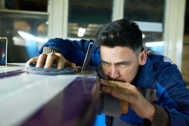 man wearing protective mask repairing boat
